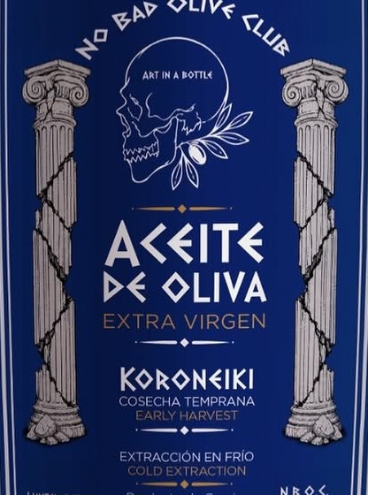 No Bad Olive Club bottle. The label reads Aceite de Oliva Extra Virgen, Koroneiki, with the skull and olive mark.