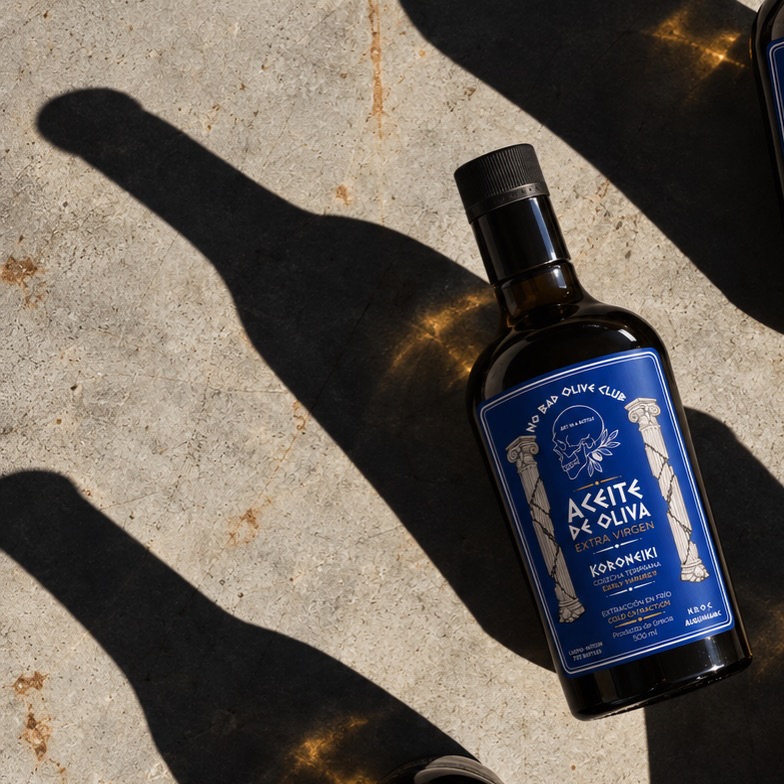 The bottle on stone. The oil’s color in the light. The skull and olive mark on the label.